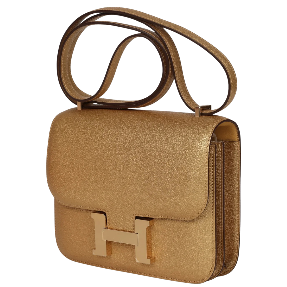 Hermes Constance 18 Dore Chamkilight Chevre left side profile, displaying the expandable gussets and adjustable shoulder strap.