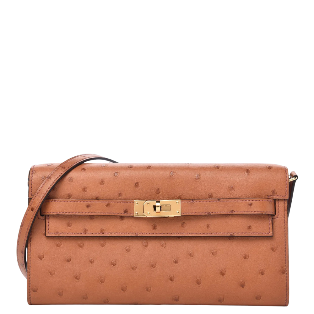 Hermès Kelly Wallet in Gold Ostrich leather with Gold Hardware, luxury designer wallet displayed on a white pedestal.