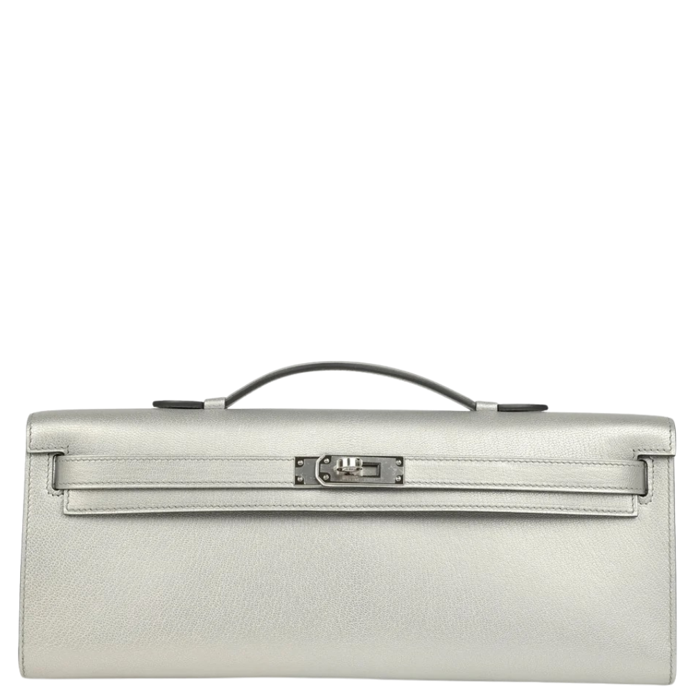 Hermes Kelly Cut Argent Chevre Chamkilight front view, showcasing the sleek elongated clutch silhouette and iconic turn-lock closure.