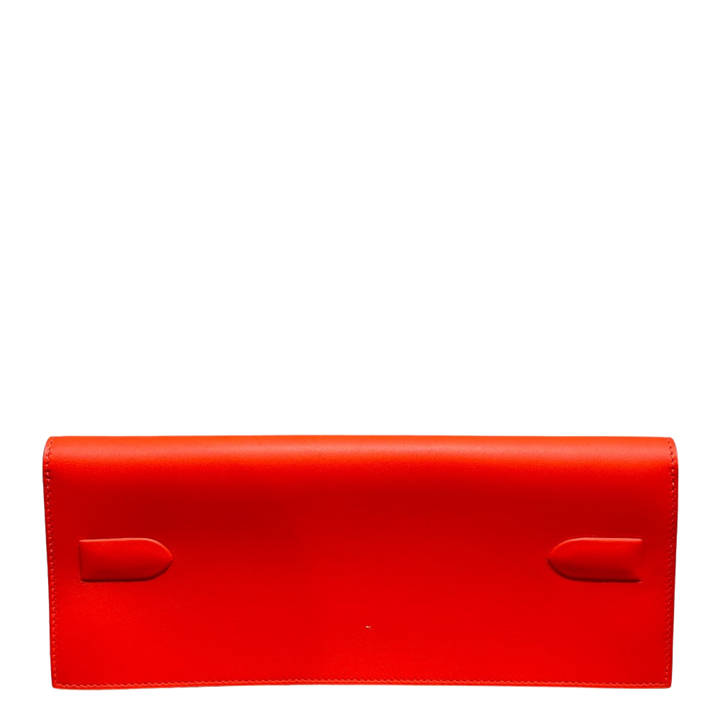 Hermes Kelly Pochette Shadow Orange Swift back view, highlighting the seamless, smooth fine-grained orange leather and clean structural lines.