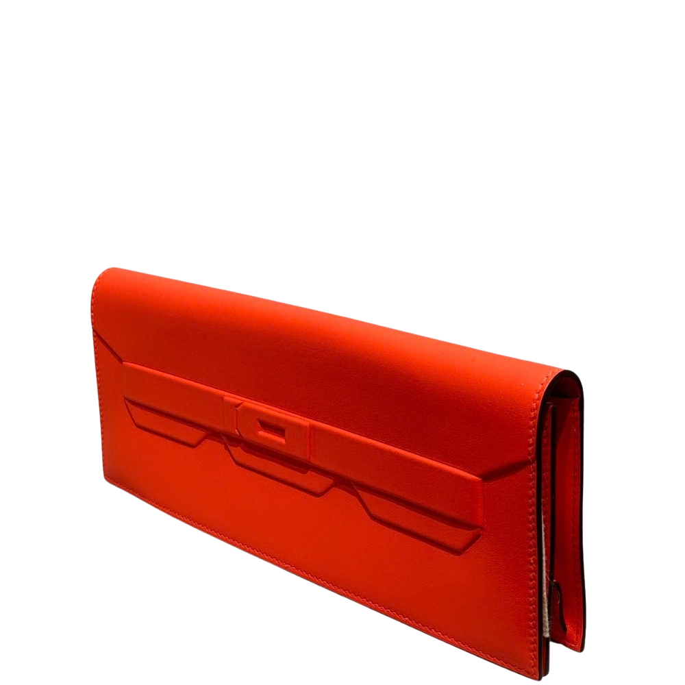 Hermes Kelly Pochette Shadow Orange Swift right side profile, featuring the smooth integrated flap proportions without traditional metal hardware.