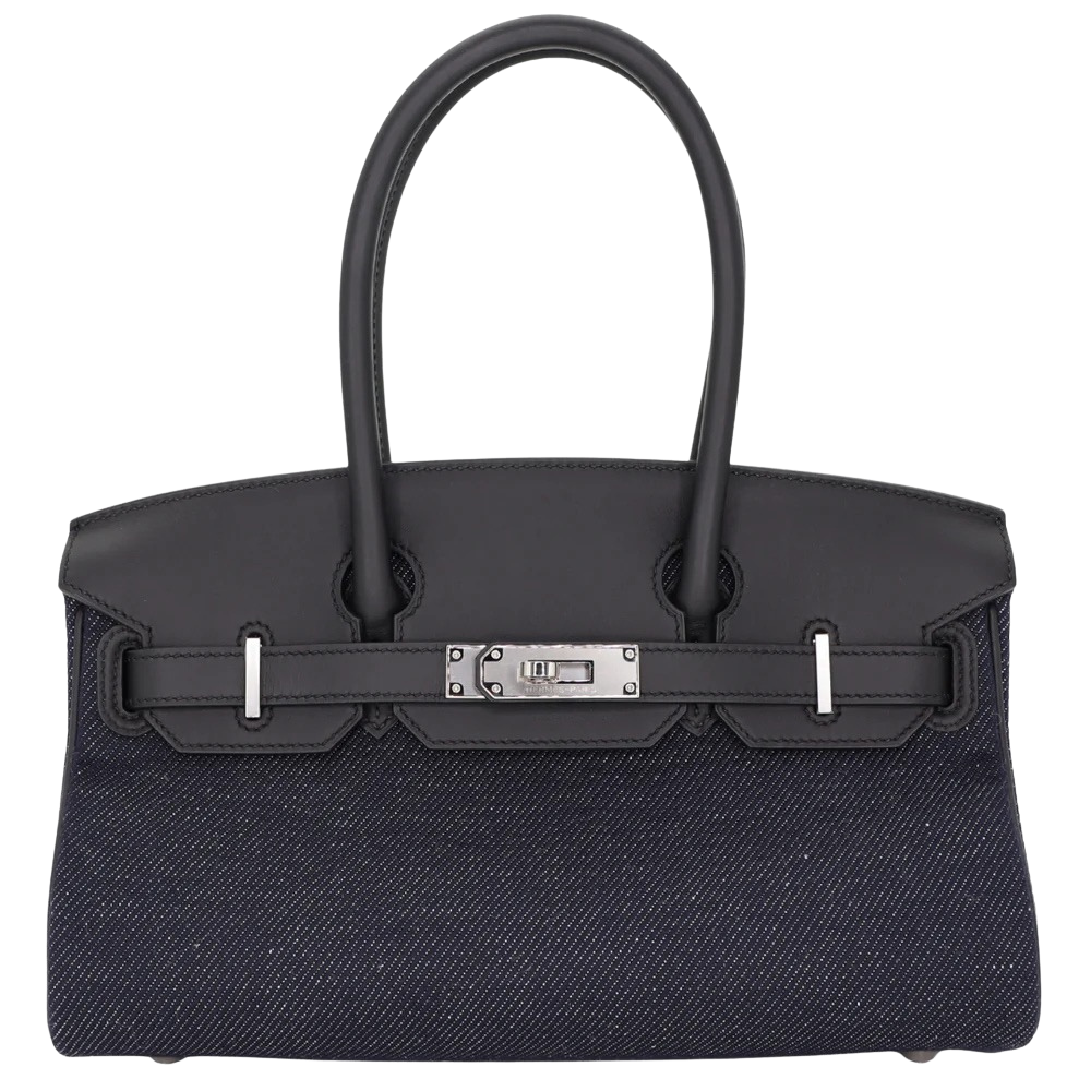 Hermes Shoulder Birkin 29 Denim Black Swift front view, showcasing the elongated horizontal silhouette, blue denim body with black leather trim, shoulder handles, and silver turn-lock hardware.