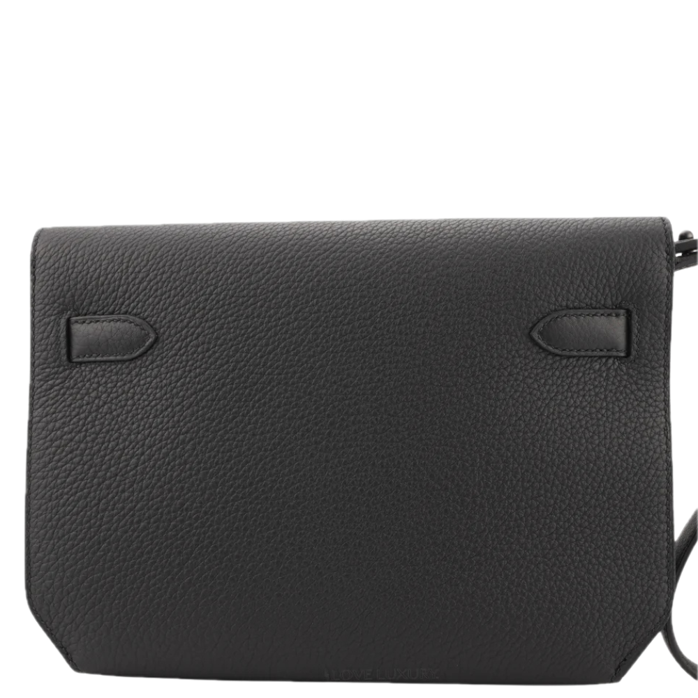 Black Kelly Depeche Hermès leather crossbody bag with a rectangular shape, front strap loops, and a side strap visible on the right for men